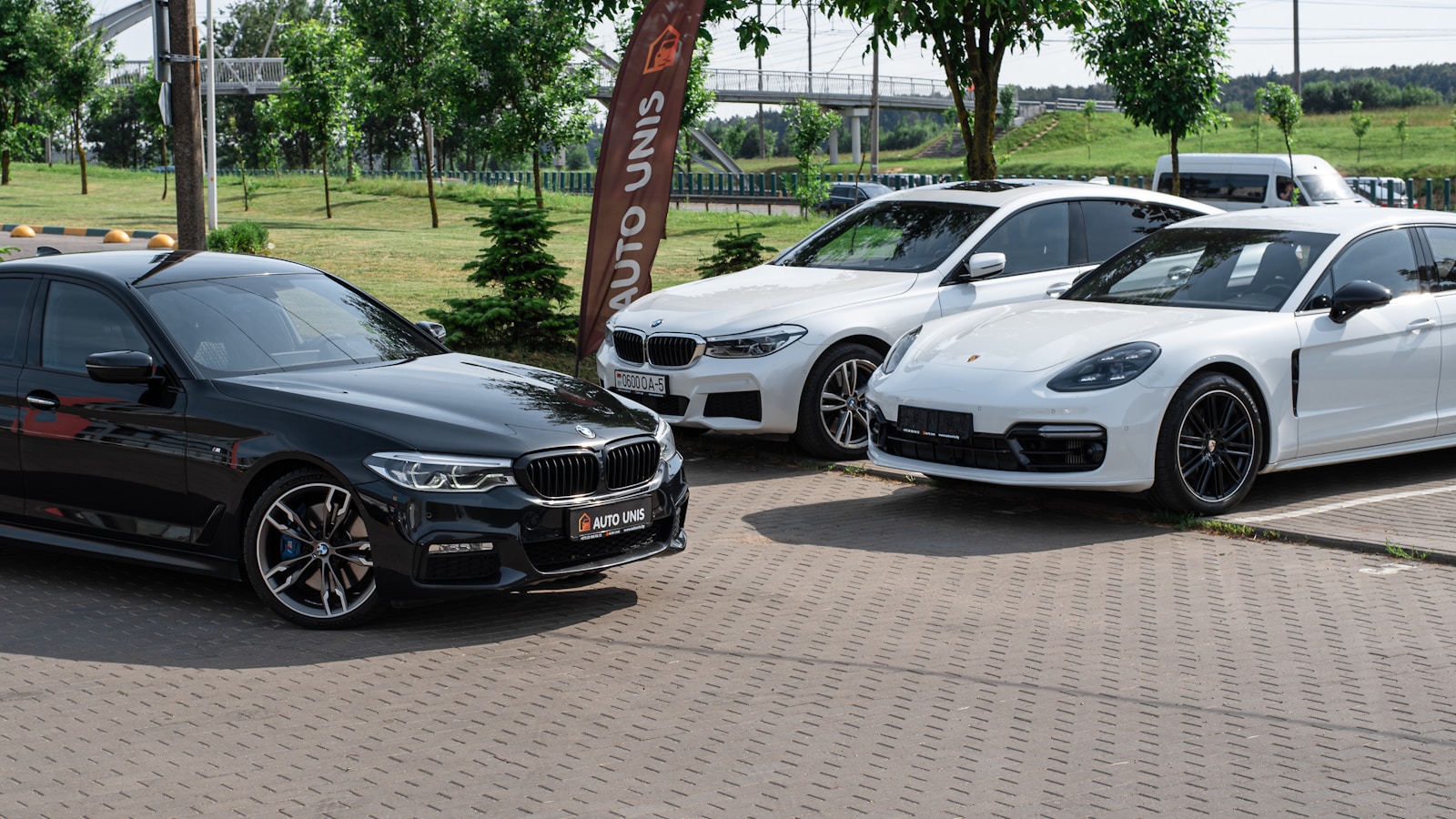 a group of cars parked on a brick road